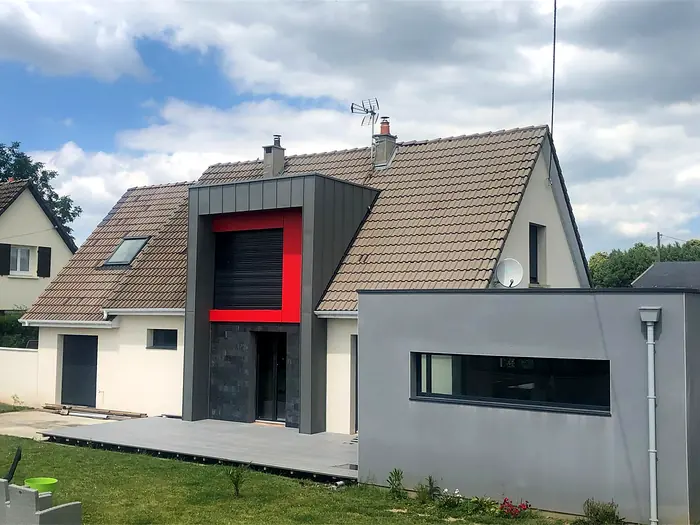 Maison avec extension, habillage en zinc et accent rouge